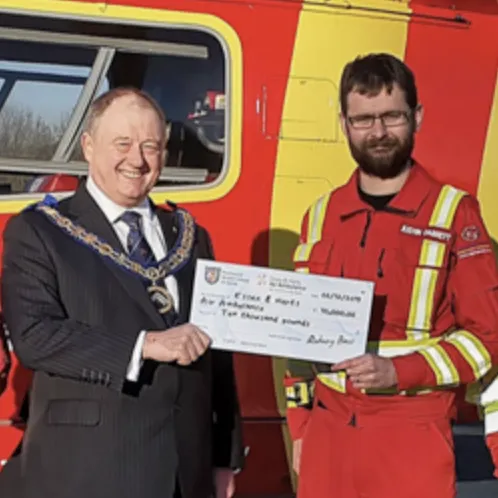A delegate from Essex Freemasons presenting a cheque to Essex Fire and Rescue.